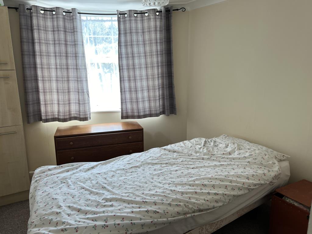 Lot: 10 - THREE-BEDROOM FLAT FOR INVESTMENT OR OCCUPATION - Bedroom two with smooth painted walls and beige carpet